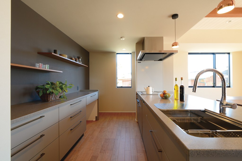 飾り棚を設えたキッチン収納には奥行きと幅に十分にゆとりを持たせたカウンター収納を採用。また、東側には積極的に窓を設けて、心地良い朝日を採り込む。